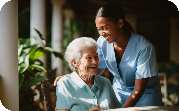 A joyful elderly woman and a compassionate nurse share a light-hearted moment in a serene outdoor setting.