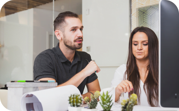 Two environmental engineers, a man and a woman, working together in a modern coworking office space